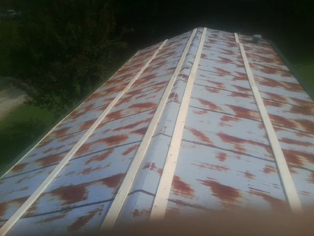 Rusted metal roof panels with new wood purlins before replacement — Storm Damage Roof Repair in Boonton by Roofing Brothers