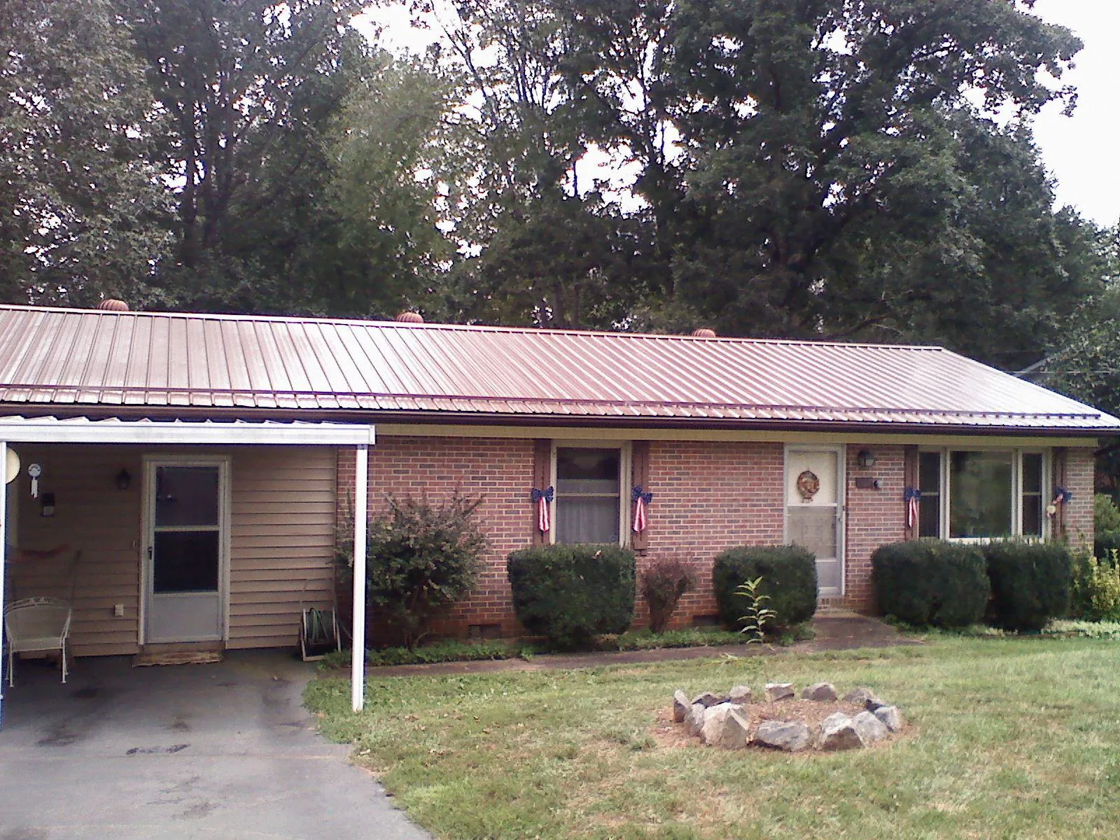 Bronze metal roof and carport on a brick ranch home — Roof Repair work by our crew in Boonton