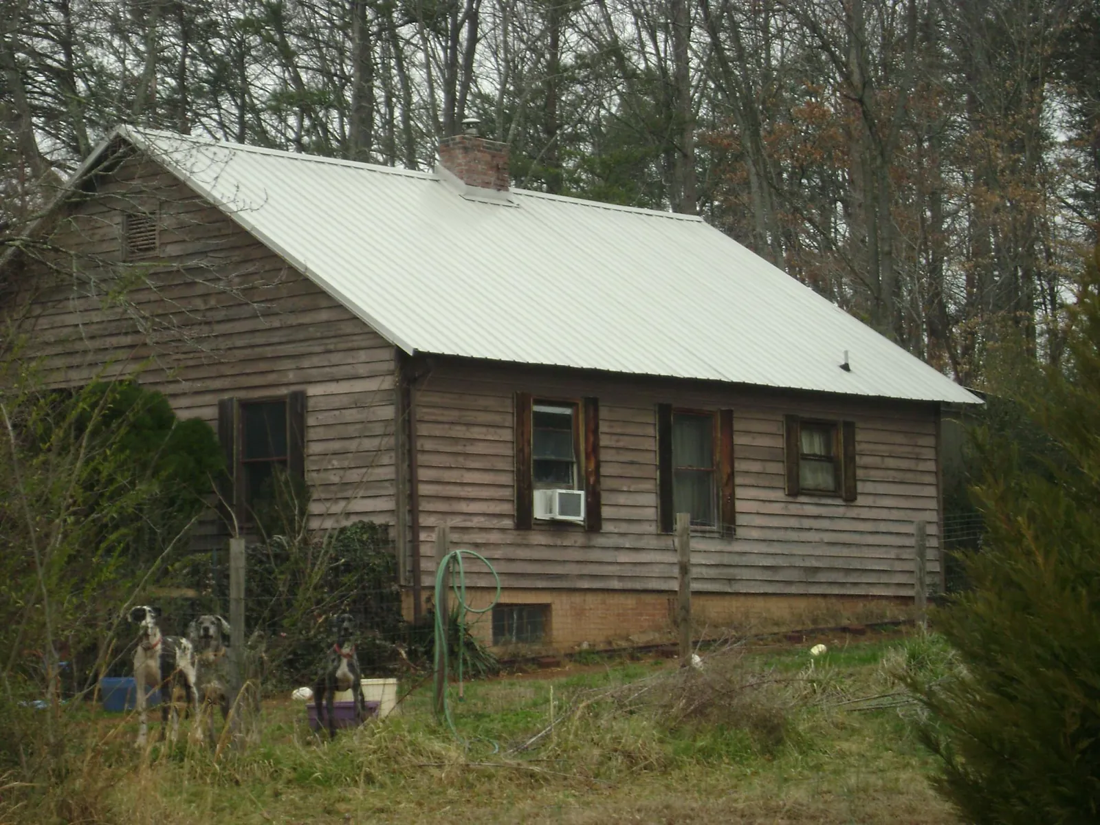 White metal roof on an old wood sided farmhouse, from a Metal Roof Installation job in Boonton